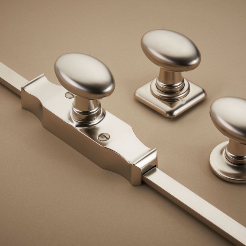Cremone mechanism beside coordinating oval knobs